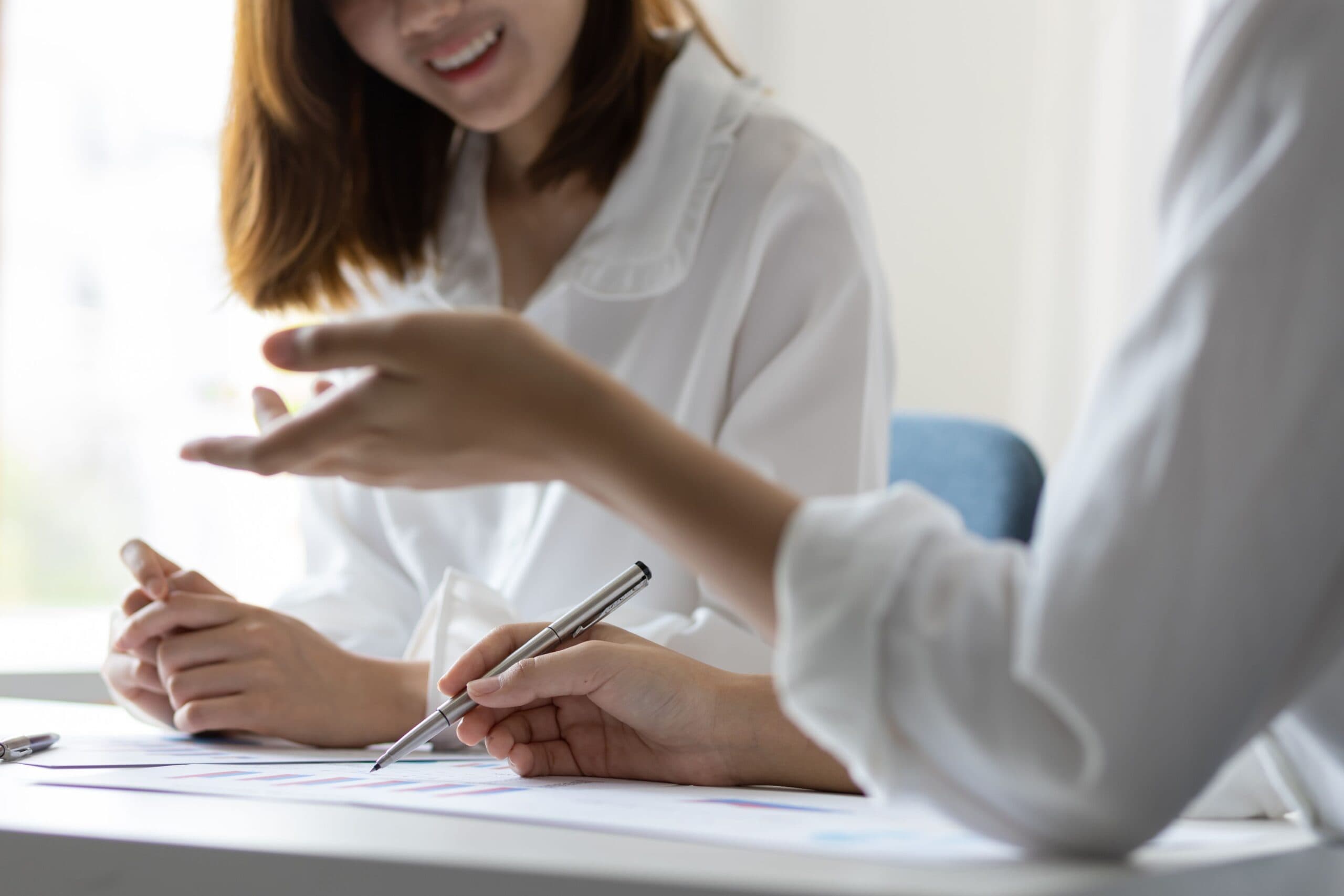 Hands reviewing documents with a pen